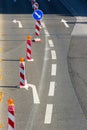 Red and white construction roadblocks with direction signs, sunny day Royalty Free Stock Photo