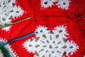 Red and white crochet snowflake with hooks