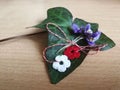 Red and white crocheted flowers martisor with violet spring flowers Royalty Free Stock Photo