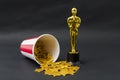 Red and white cup with golden stars and plastic oscar award