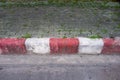 The red and white curb striping or road markings on the roadside. Royalty Free Stock Photo