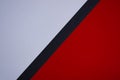 Red and white diagonally divided background with black stripe