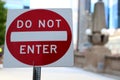 Red and white do not enter  street sign with city road behnd Royalty Free Stock Photo