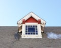 Red and white dormer on historic building