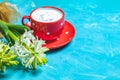 Red in white dotted cup of coffee and white hyacinths Royalty Free Stock Photo