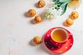 Red in white dotted cup of tea, profiteroles and hyacinths Royalty Free Stock Photo