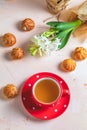 Red in white dotted cup of tea, profiteroles and hyacinths Royalty Free Stock Photo