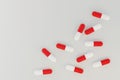 red and white drug medical capsule on the ground,