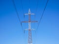 Red white electricity pylon against blue sky Royalty Free Stock Photo