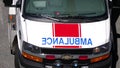 Red and white emergency lights flashing on ambulance car