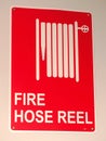 Red on white fire hose reel sign Royalty Free Stock Photo