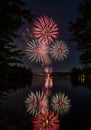 Red And White Fireworks Display Over Lake At Night Royalty Free Stock Photo