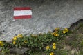 Red and white flag of Austria as a route marker to Grossglockner rock summit in Austrian Alps