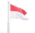 The red and white flag of the Republic  Indonesia flying on the flagpole Royalty Free Stock Photo