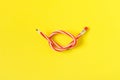 Red and white flexible pencil. on yellow background