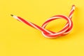 Red and white flexible pencil. on yellow background