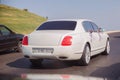 Red and white flowers bouquet . Closeup image of wedding car decoration . Wedding decorations on the hood of the car. Road .