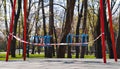 Restriction tape on swings on empty children playground due to covid19 outbreak Royalty Free Stock Photo