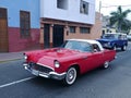 Red and white Ford Thunderbird and a blue and white Ford Bronco going to an exhibition in Pueblo Libre district of Lima Royalty Free Stock Photo