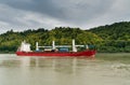 Red and white freighter container ship traveling along the Seine River from Paris to the English Channel Royalty Free Stock Photo