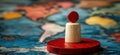 Red and white game piece on world map background representing strategy and exploration Royalty Free Stock Photo