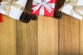 Red and white gift box with pine cones on wood table Royalty Free Stock Photo