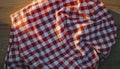 Red and White Gingham Checkered Fabric Cloth on Wooden Surface pattern Royalty Free Stock Photo