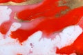 Red, white and gold paint liquid background. Abstract rich texture.