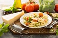 Red, white and green tortellini with vegetables and cheese