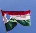 Red-white-green Hungarian flag flies in the sky Royalty Free Stock Photo