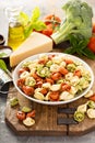 Red, white and green tortellini with vegetables and cheese