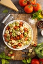 Red, white and green tortellini with vegetables and cheese