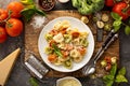 Red, white and green tortellini with vegetables and cheese