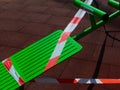 Red and white hazard and barricade tape to prevent use of exercise park Royalty Free Stock Photo