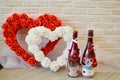 Red and white heart with roses. Two homemade bottles of champagne. Against the background of a brick wall. Royalty Free Stock Photo