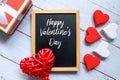 Red and white heart wooden handcraft and box white a blackboard written with Happy Valentine`s day. Royalty Free Stock Photo