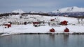 Red and white houses on Holdoya Island from Hinnoya in winter in Norway