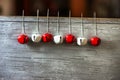 Red and white jingle bells hanging on hooks Royalty Free Stock Photo