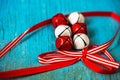 Red and white jingle bells with ribbon n blue background Royalty Free Stock Photo