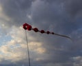 Kite flying on a cloudy sky background Royalty Free Stock Photo