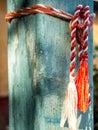 Red and white knitting string tied up on house wooden pillar martisor romanian 1st of march celebration concept