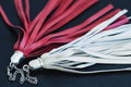 Red and white leather tassel on a metallic silver chain keychain ring, texture, background