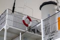 A red and white life ring on the upper deck of an old ship Royalty Free Stock Photo