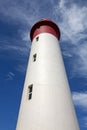 Red and White Lighthouse Extending Towards Blue Cloudy Sky