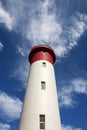 Red and White Lighthouse Extending Towards Blue Cloudy Sky