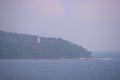 Red White Lighthouse in Forest on North Bay Island with Ocean and Cloudy Sky with Thunder Storm - Andaman Nicobar, India Royalty Free Stock Photo