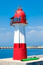 Red-white lighthouse at sea