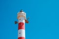 Red,white lighthouse tower isolated on blue sky Royalty Free Stock Photo