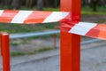 Red and white limit tape fenced around outdoor sport playground on steel pillar global quarantine conditions time Royalty Free Stock Photo