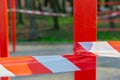 Red and white limit tape fenced around outdoor sport playground on steel pillar global quarantine conditions time Royalty Free Stock Photo